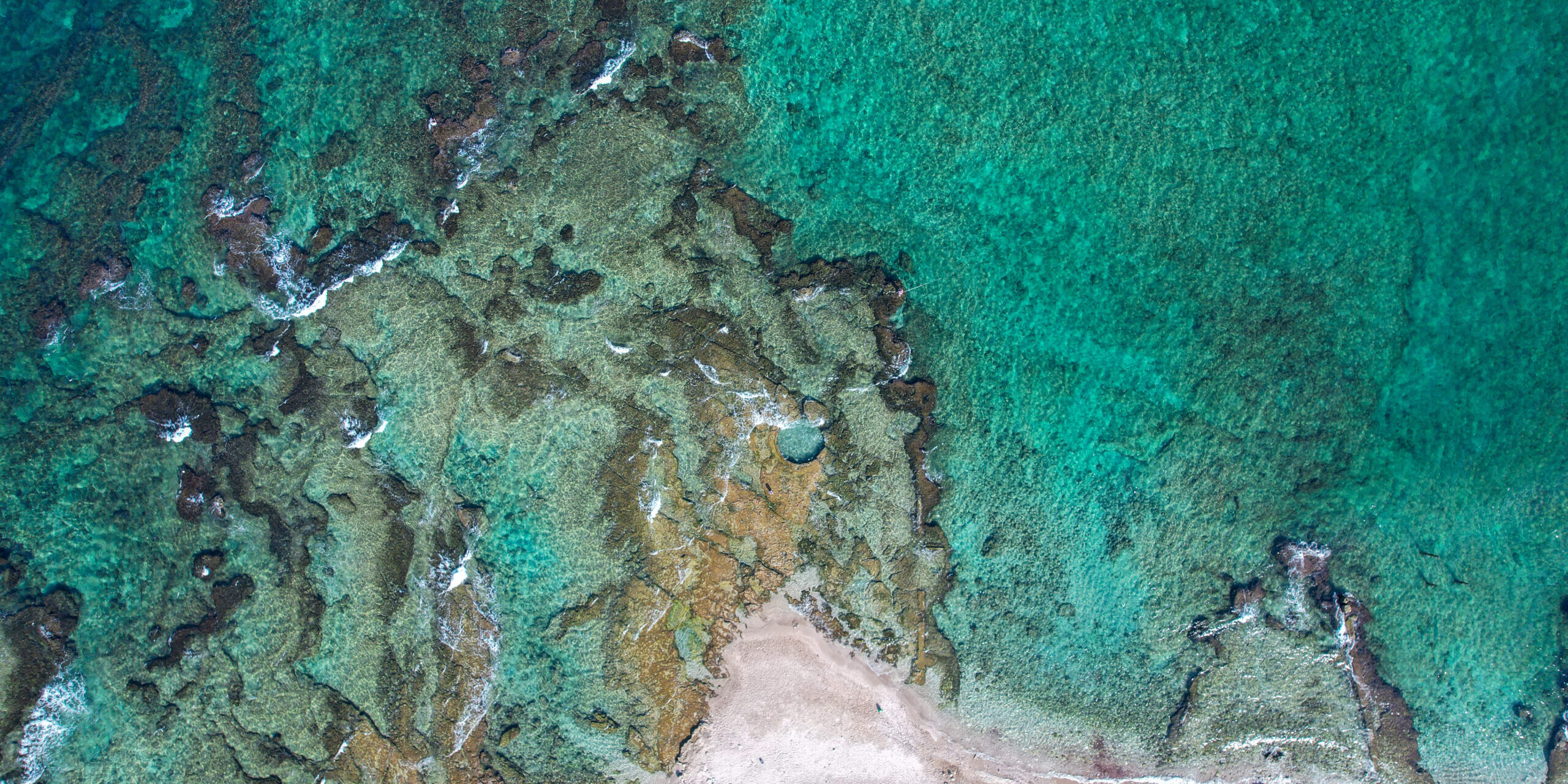 A natural pool is hewn in a natural rock near the shoreline of Haifa, Israel.